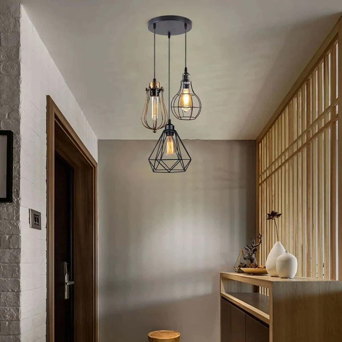 Modern cage pendant lamp with three matte metal lights, round base and metal shade, hanging from ceiling.