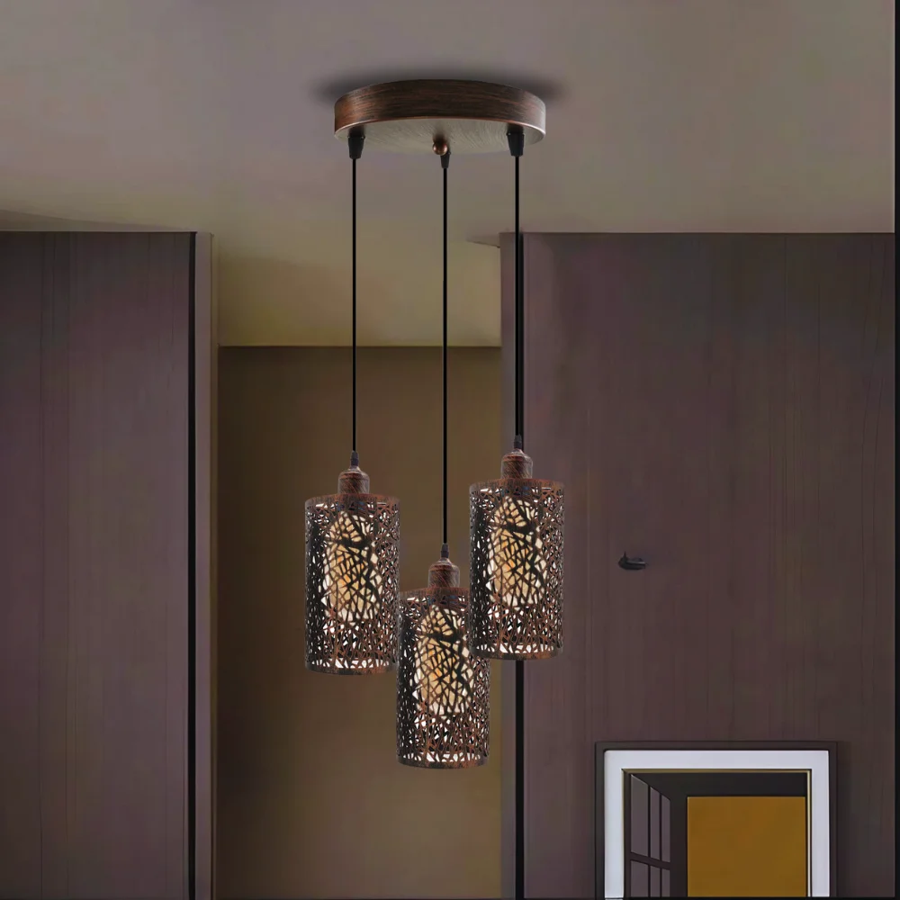 Industrial pendant light with three metal barrel cages hanging from a brushed metal ceiling rose, warm light, vintage style.