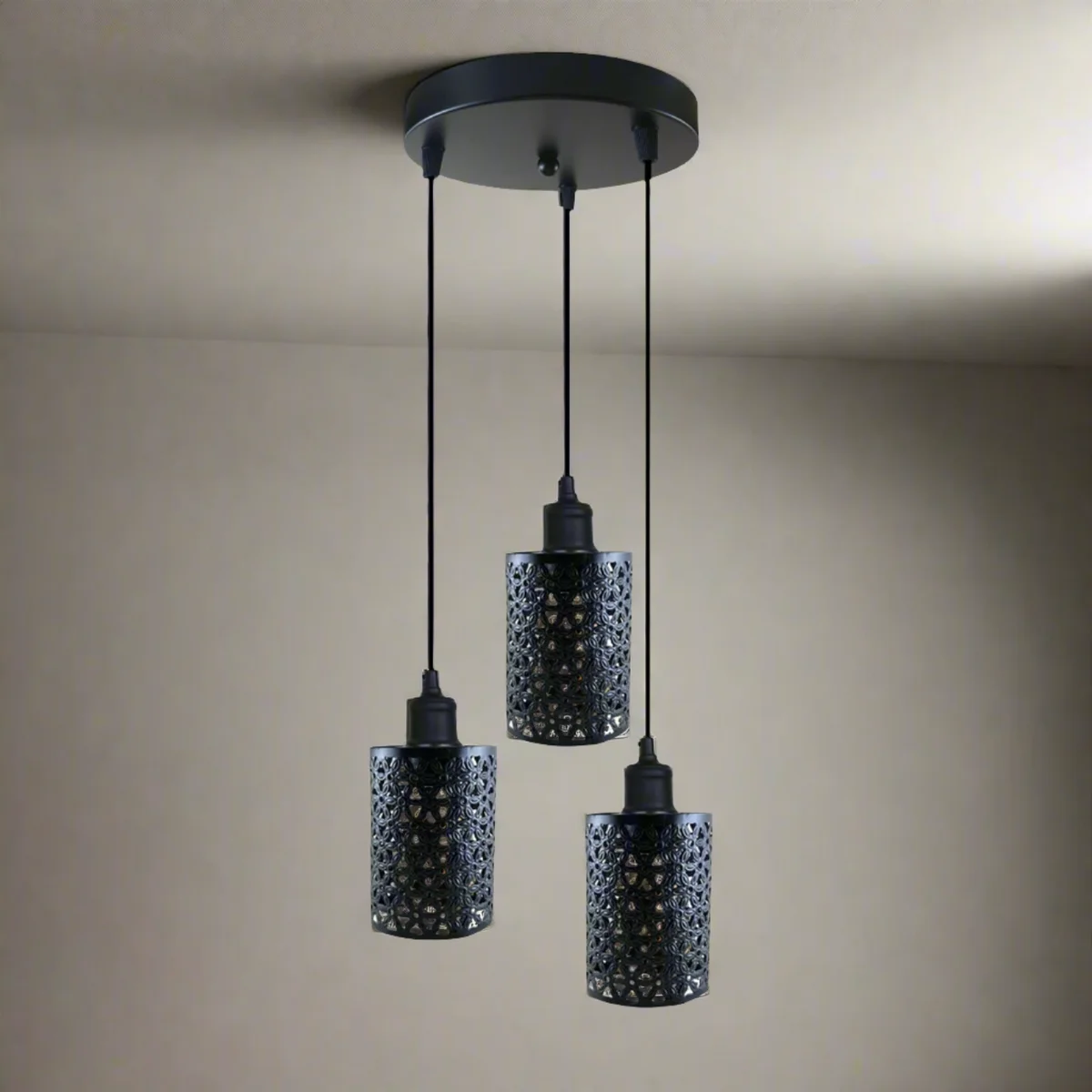 Industrial retro 3 head pendant light with three metal barrel shades hanging from a ceiling rose.