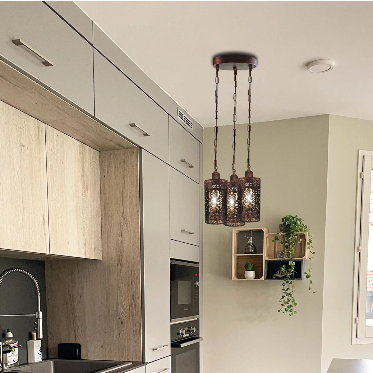 Adjustable pendant light with three metal barrel cages in brushed brass, featuring adjustable cables for customizable height