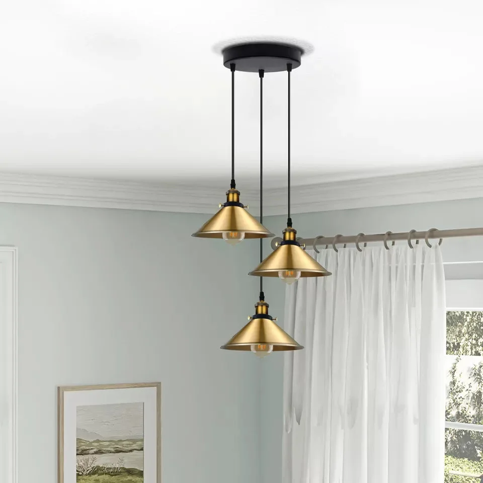 Three‑bracket vintage industrial pendant light on a round metal base, showcasing three decorative shades.