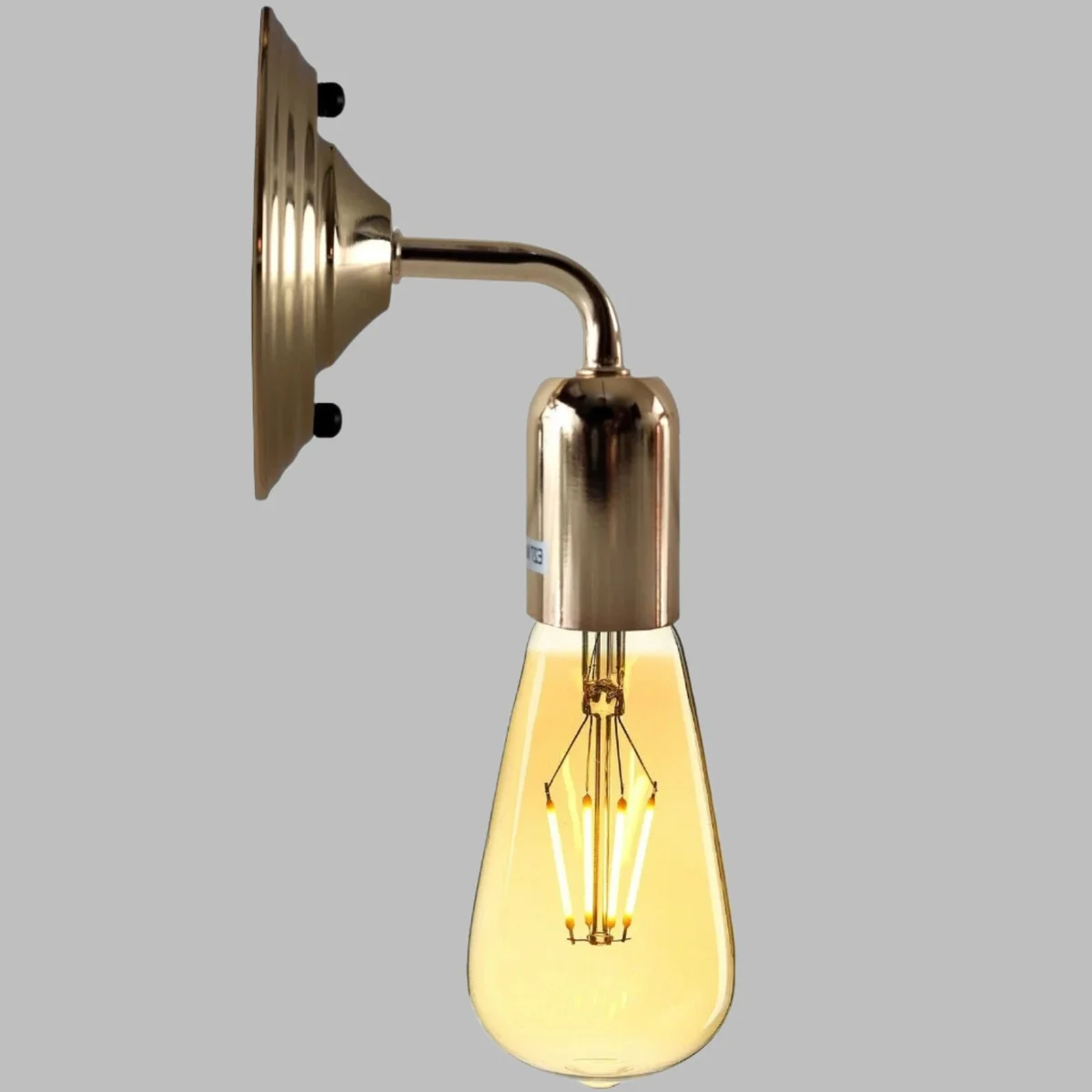 French gold vintage wall light with polished metal sconce and decorative arm.