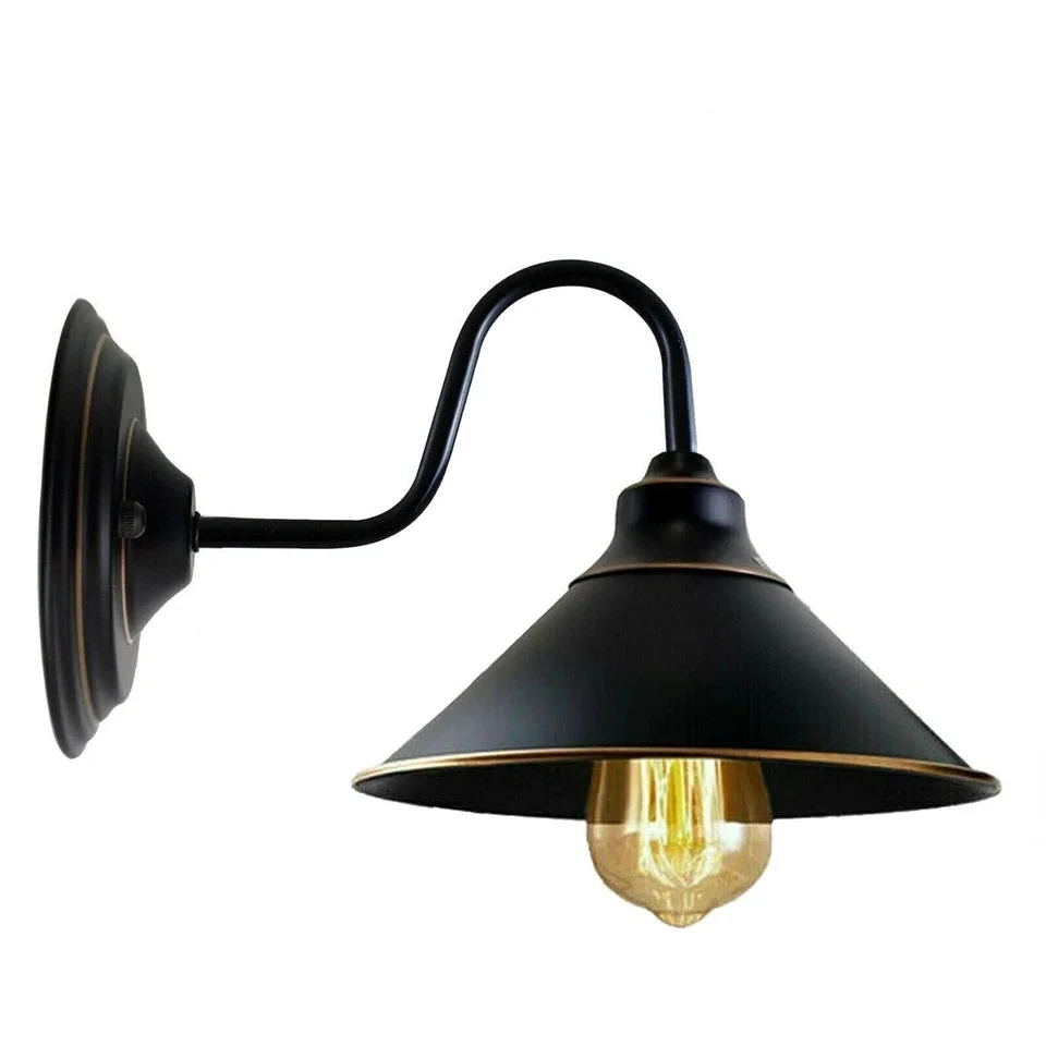 Black industrial wall sconce with metal housing, round shade and E27 socket, mounted on wall.