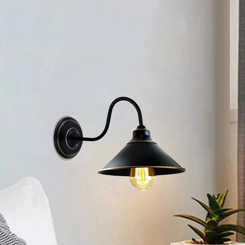 Black metal wall lamp with round canopy, E27 socket, hard wired design, sleek arm, elegant lighting fixture.