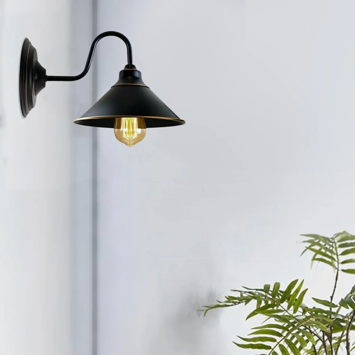 Black metal wall lamp with round black canopy, E27 socket, sleek wall‑mounted design.