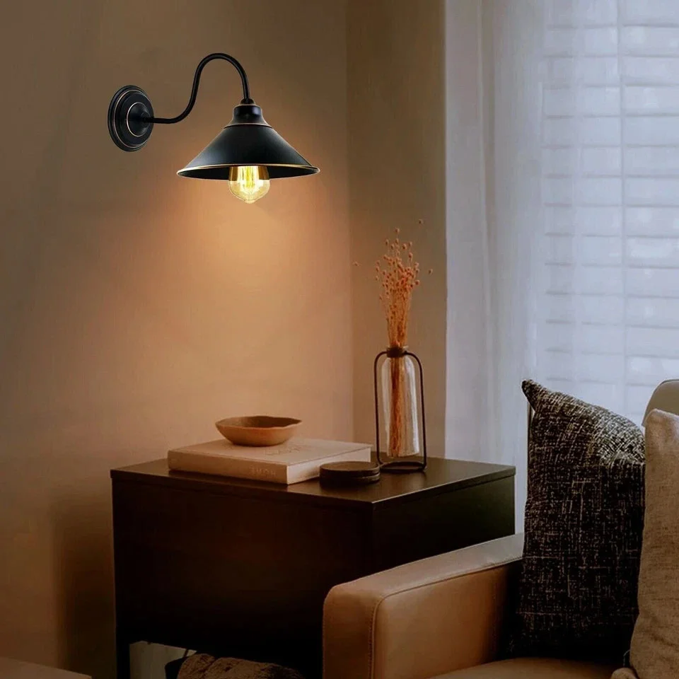 Black metal wall lamp with round canopy, black ceiling rose, sleek E27 socket holder.