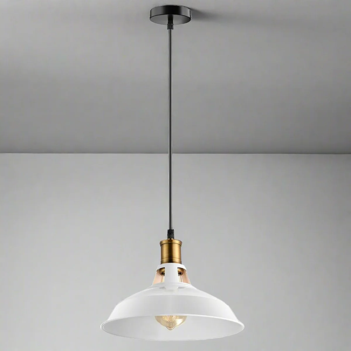 White pendant light with metal shade and gold accents hanging from a ceiling canopy, cable attached, modern retro style.