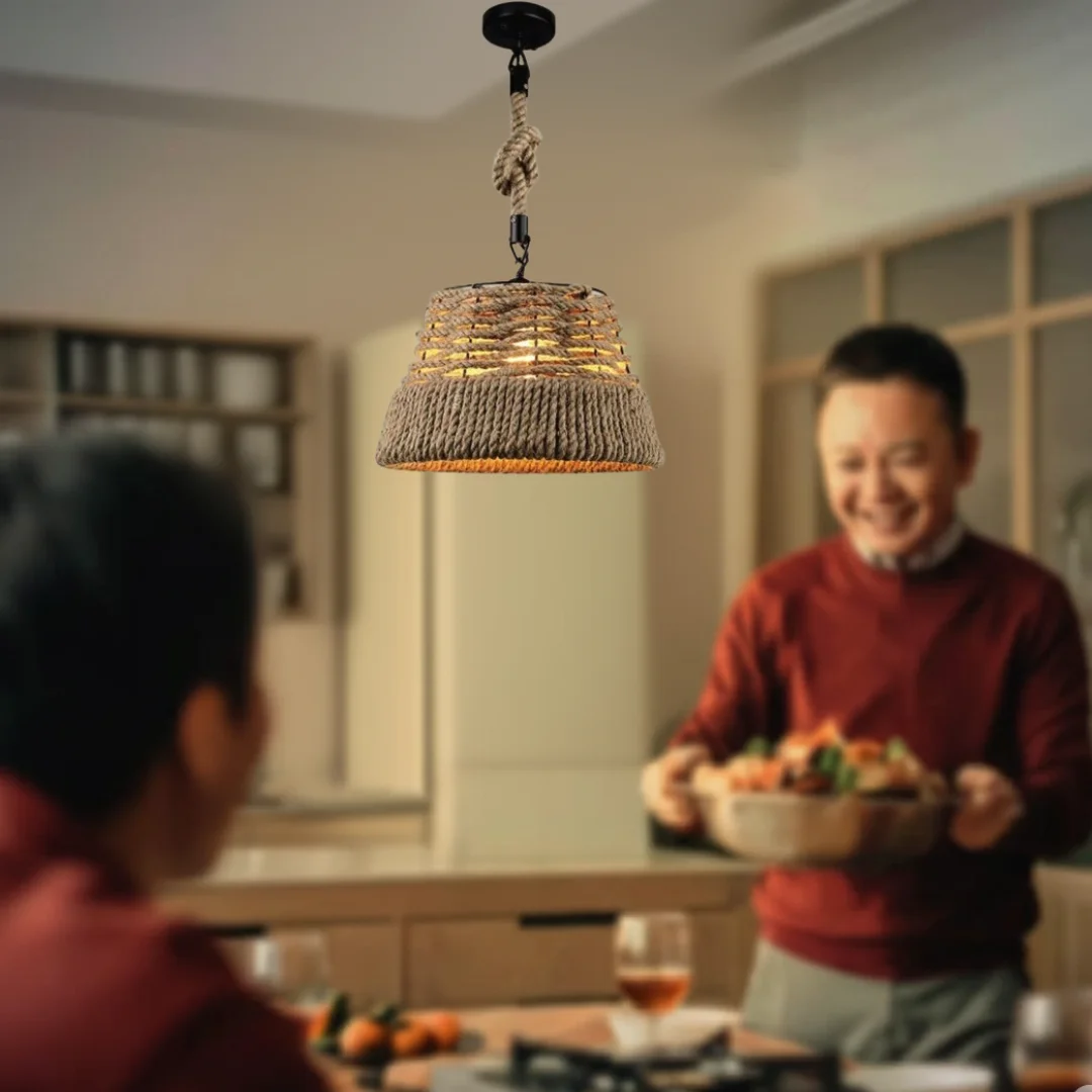 vintage industrial pendant light featuring hemp rope suspension and a rustic iron shade hanging from the ceiling