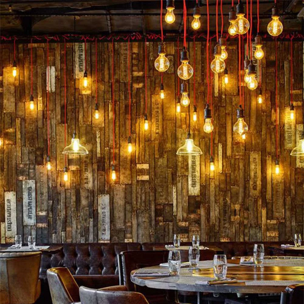 Vintage LED globe bulb with Edison spiral filament inside oversized transparent glass, 125mm diameter, warm amber glow