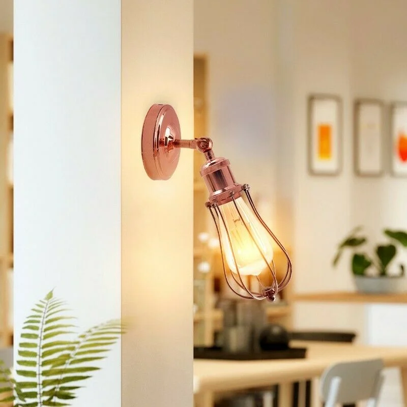 Industrial wall light with rose gold electroplated metal cage, exposed E27 socket, mounted on wall