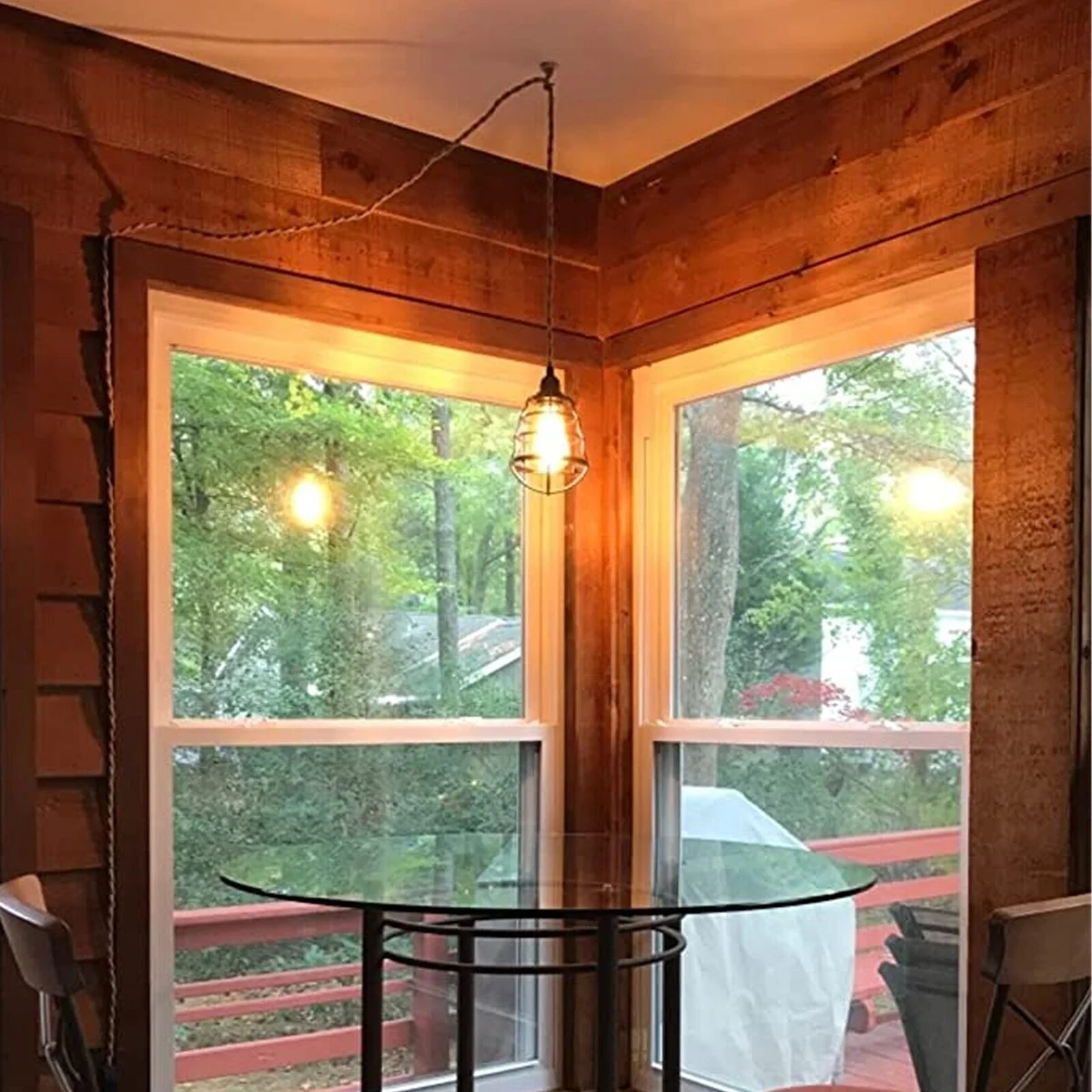 Black pendant lamp with hemp‑coated cable and metal cage, showcasing an industrial style lighting design.