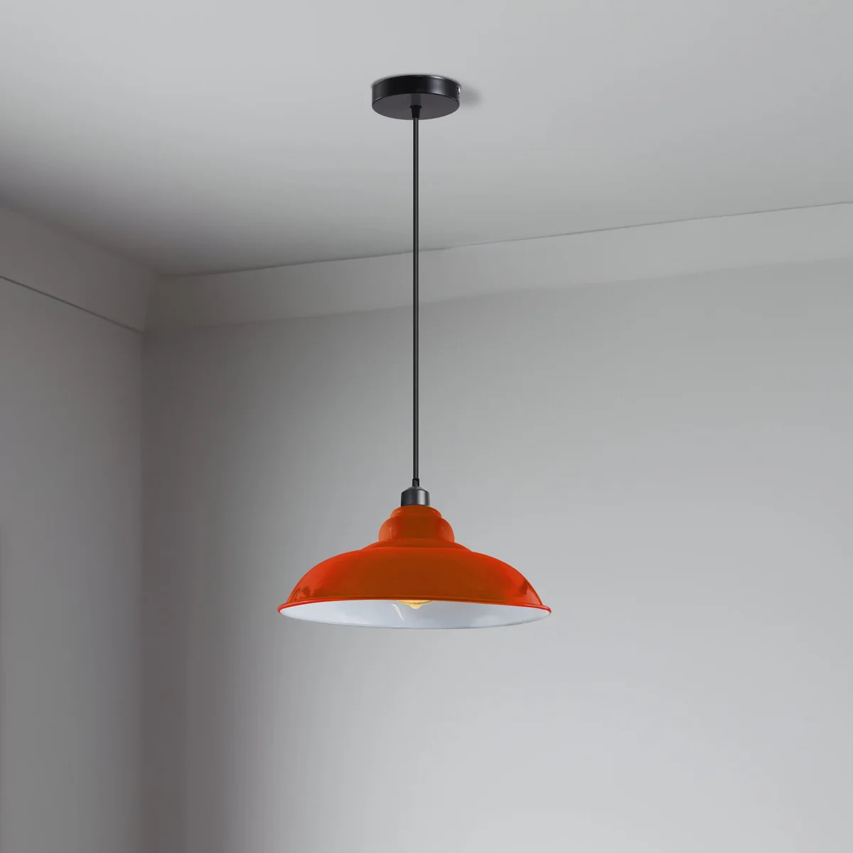 Industrial pendant lighting with orange painted metal hood, white interior, angled design, 32cm shade over kitchen island.