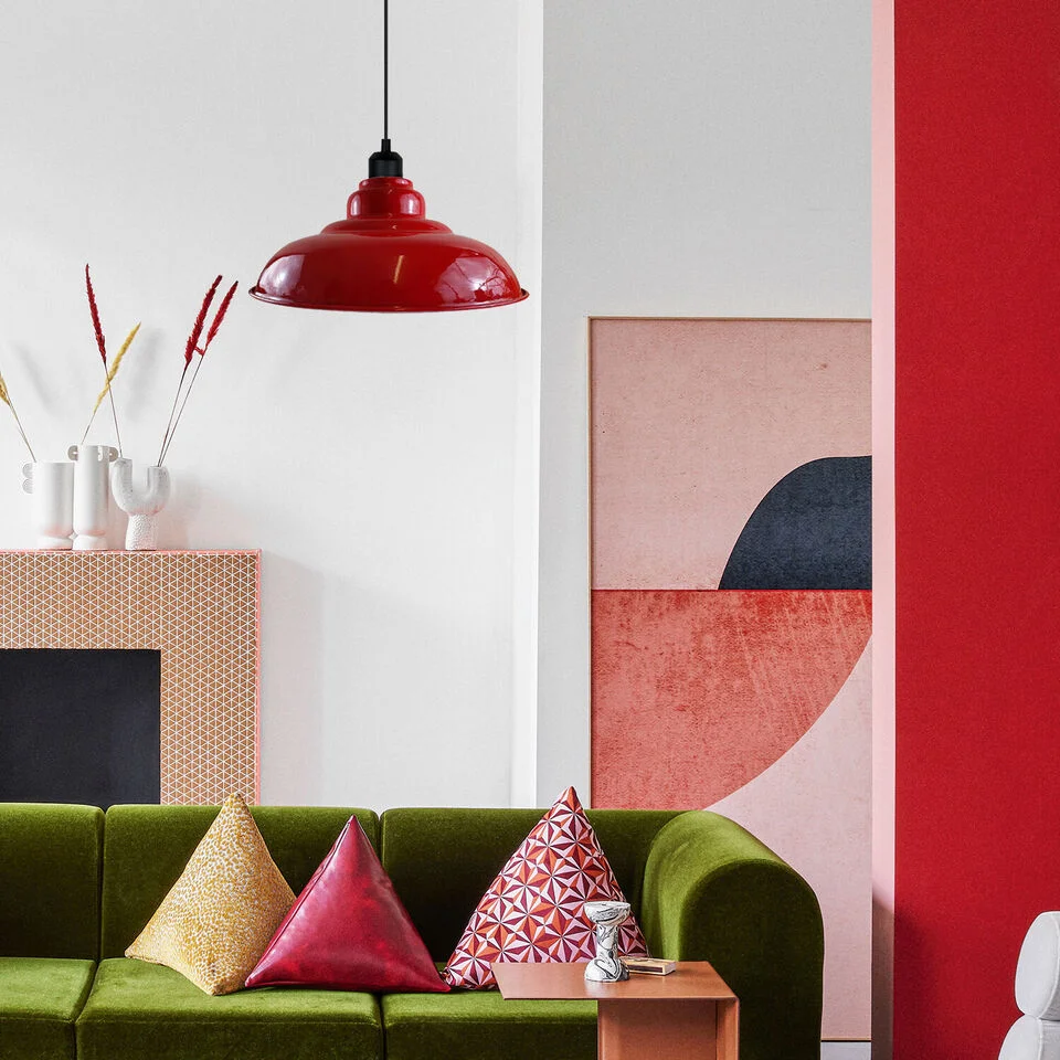 Easy fit pendant light with painted metal shade, red finish and white interior hood, hanging over a kitchen island.