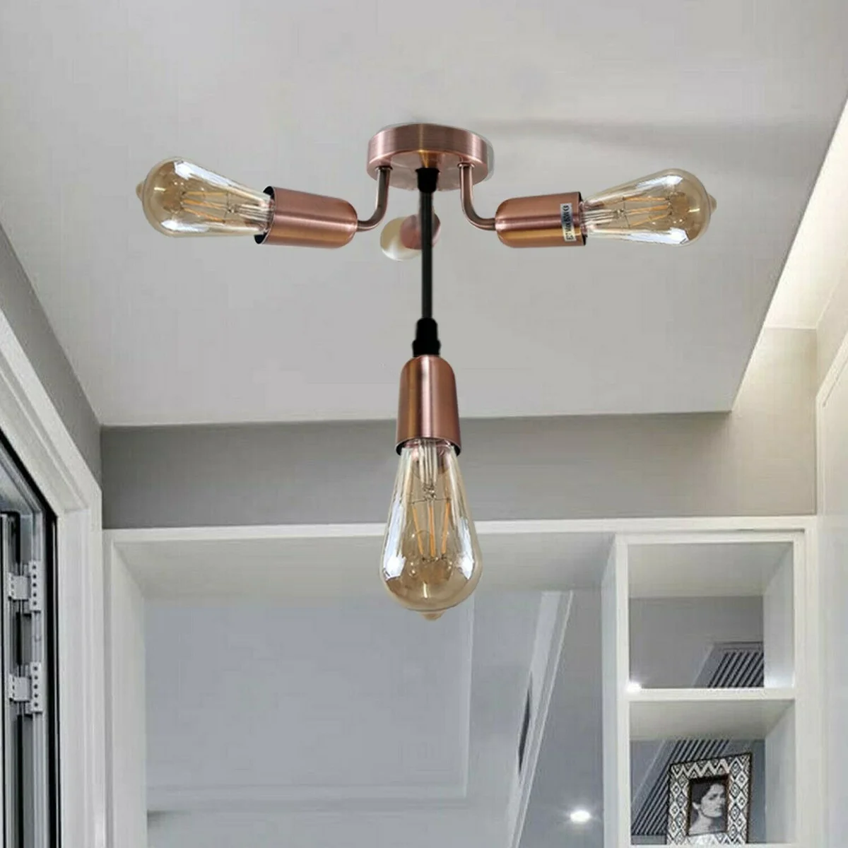 Flush‑mounted industrial ceiling light featuring four copper metal light holders on a narrow metal plate.