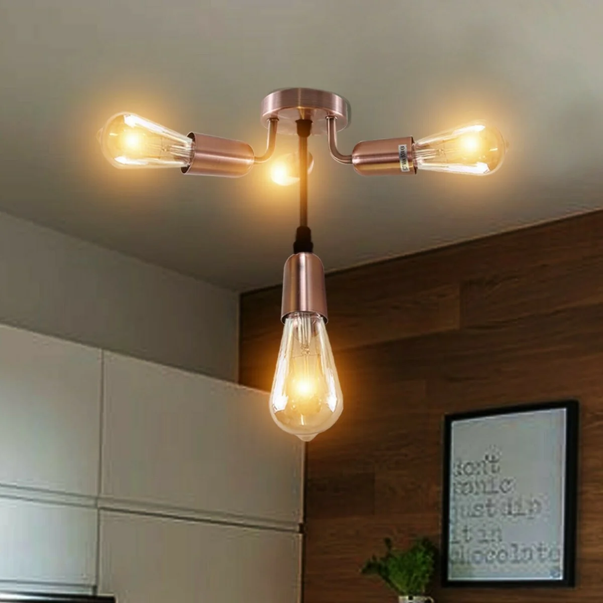 Flush‑mounted industrial ceiling light with 4 copper cage lamps on a metal base, E27 sockets, warm decorative shade.