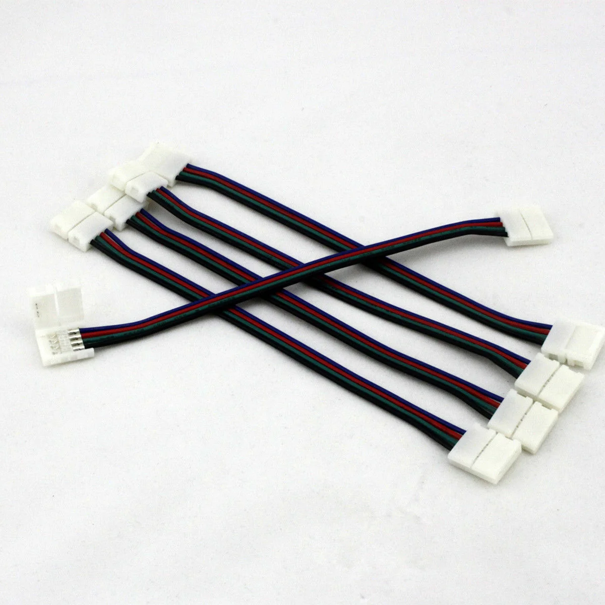 LED strip connector cable with sharp pins and coloured wires, covered in durable plastic, ready to attach to LED strip