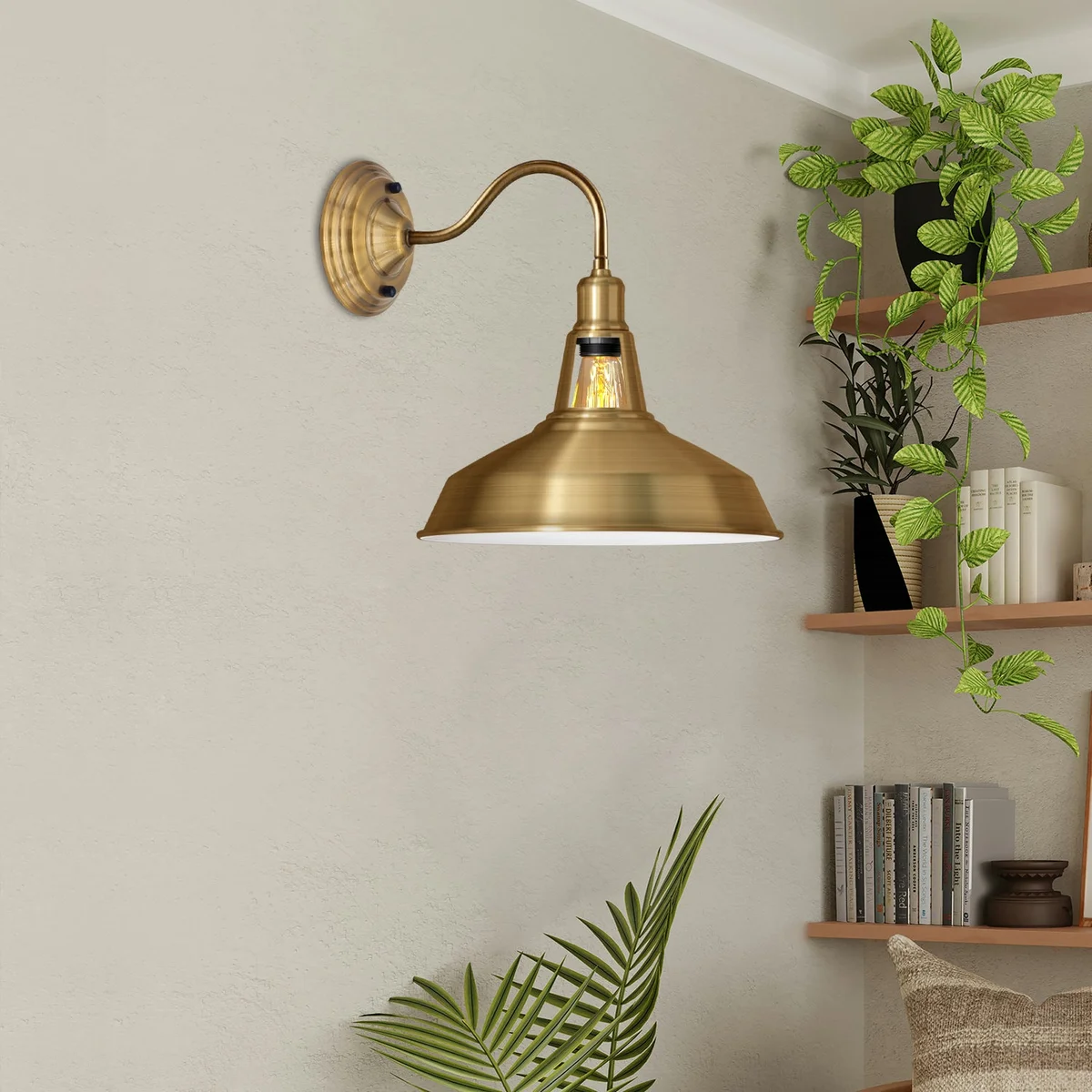 Yellow brass vintage industrial wall light with barn shape metal shade, mounted on wall with lamp holder, classic retro style.