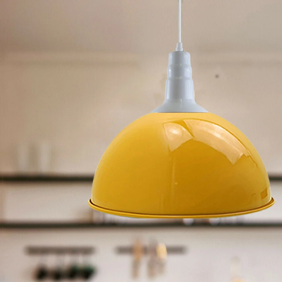 Three yellow industrial pendant lights on a metal base with PVC cable, hanging over a kitchen counter.