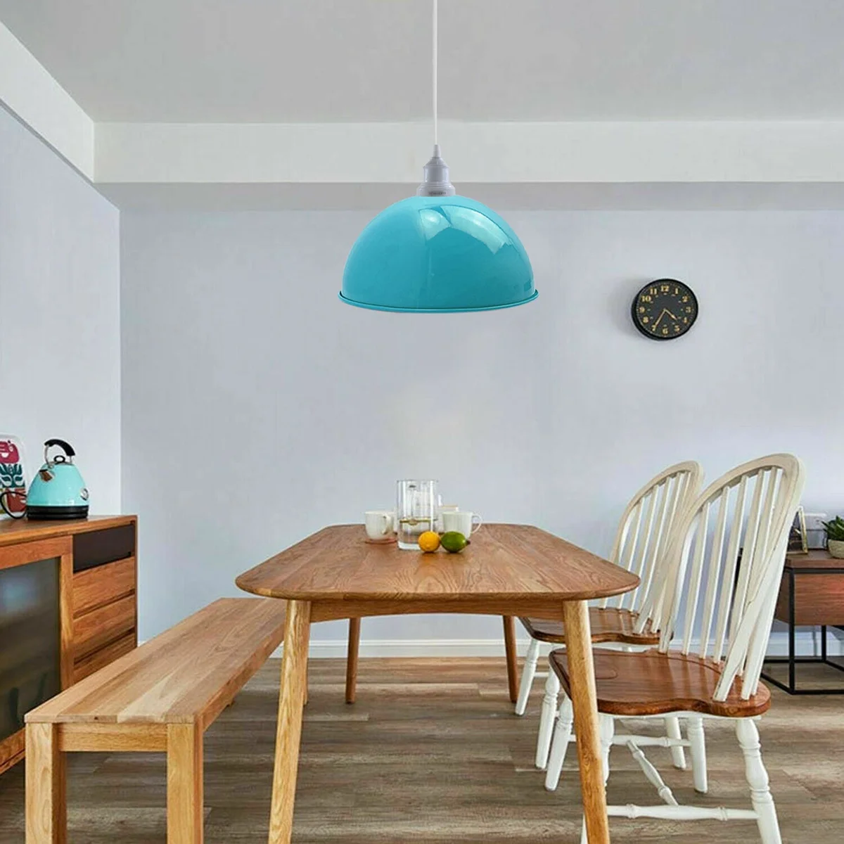 Blue industrial pendant lights with metal shades suspended over a kitchen island, a stylish kitchen island pendant