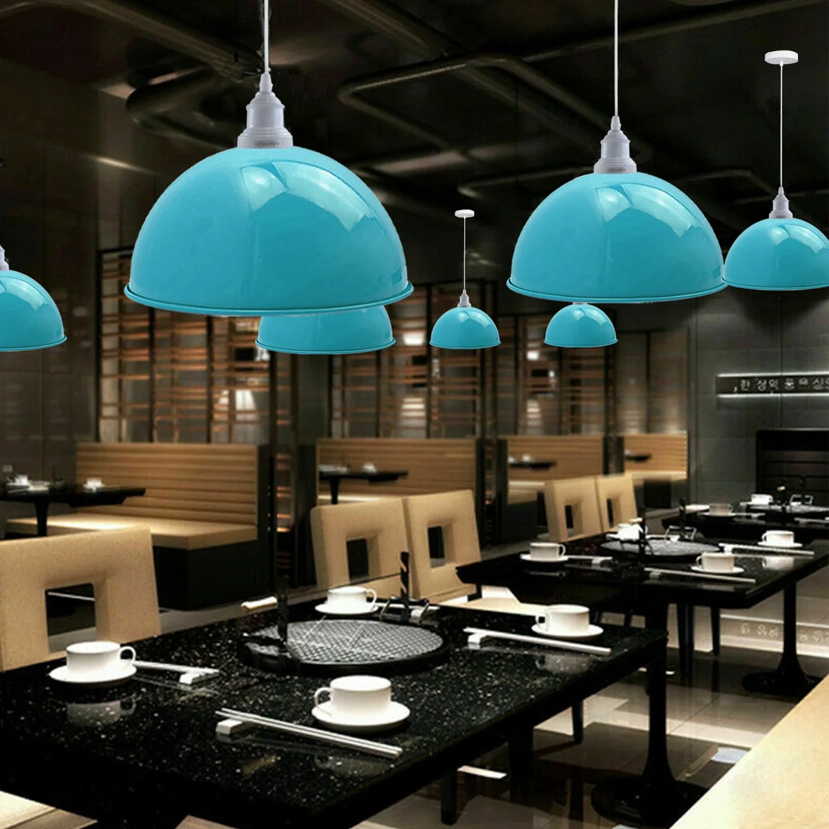 Three hanging vintage industrial blue metal shade lamps with white lamp holders, placed over a kitchen island.