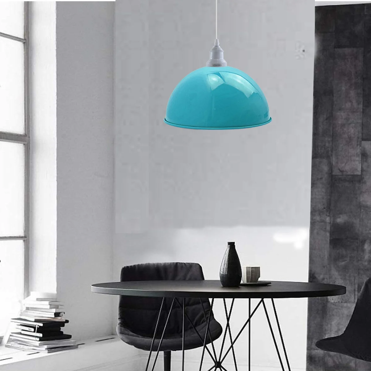 Blue metal pendant lamps with white bulbs and iron shades suspended above a dining area, showcasing retro loft lighting.