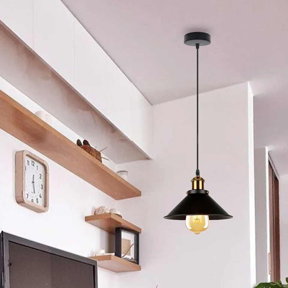 Group of three rustic pendant lights with black metal lampshades and adjustable 95 cm cables hanging over a dining table