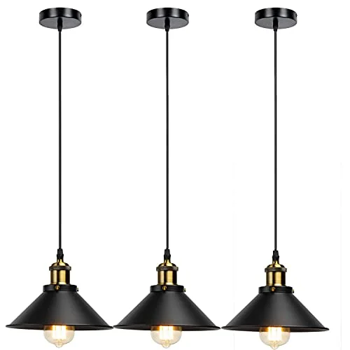 Three vintage style lighting pendants hanging over a dining table.