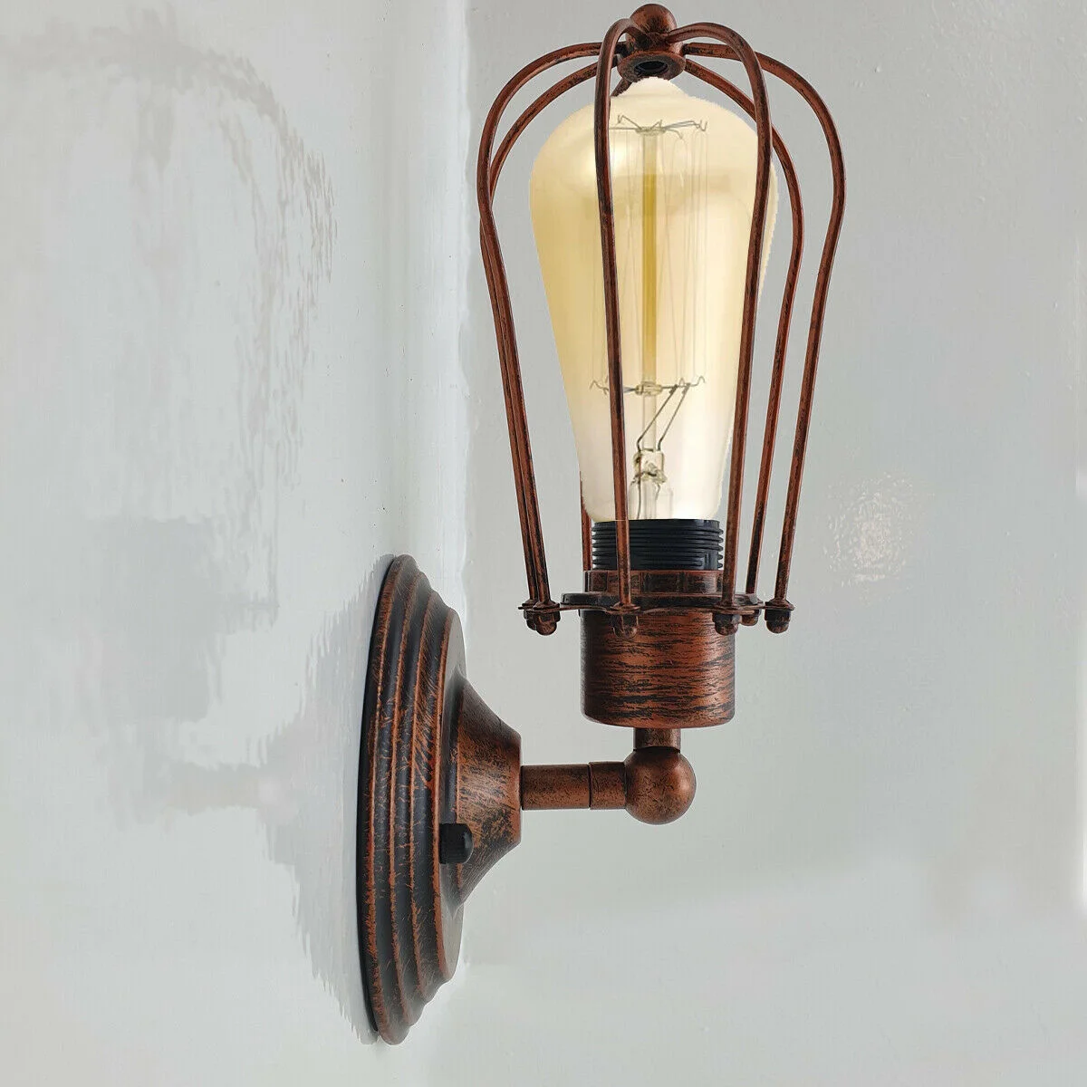 Industrial cage wall light in black metal cage, warm light from E27 bulb, vintage retro design on wall