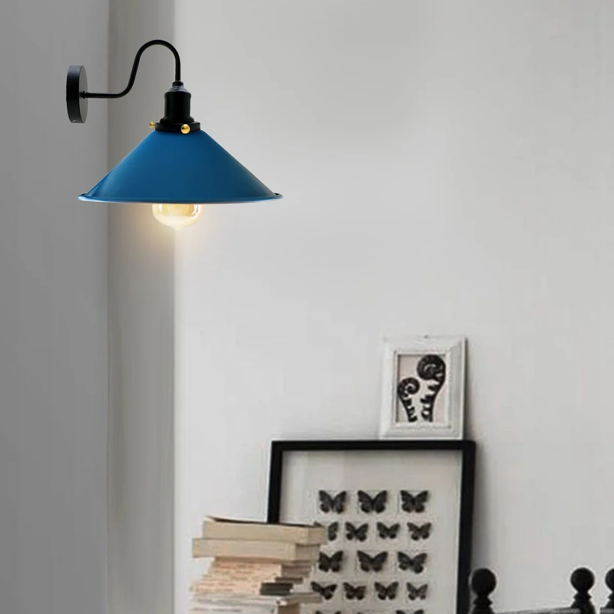 Blue industrial wall light with swan neck mount and metal conical shade hanging from ceiling