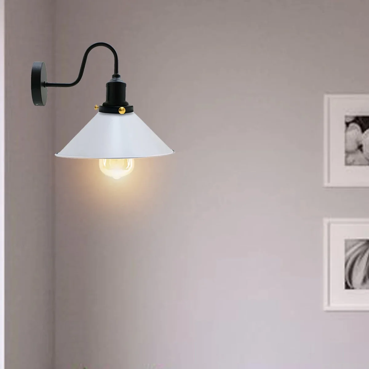 White industrial wall light with cone metal shade and swan neck arm mounted on wall, showcasing vintage style.