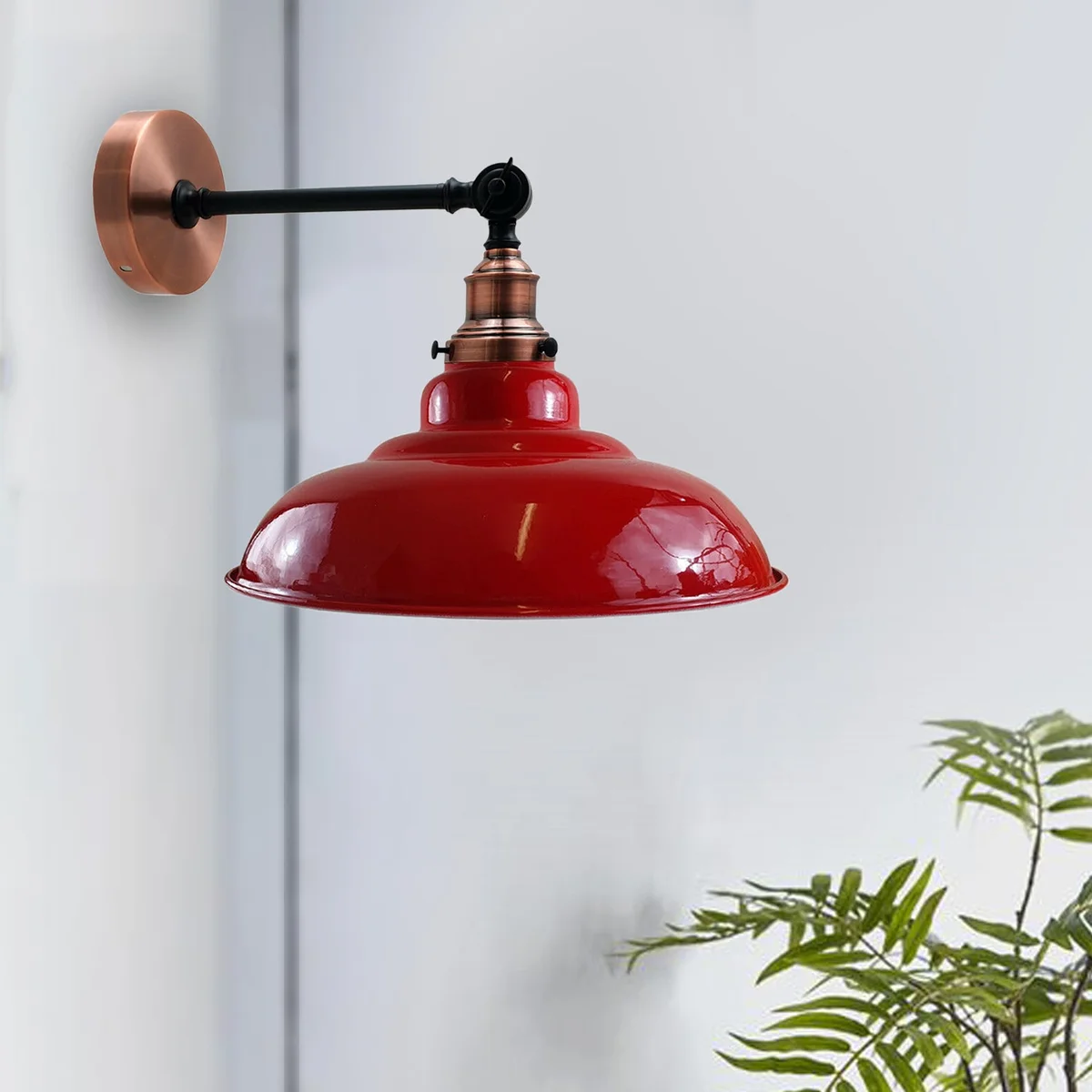 Red adjustable wall lamp with curved metal shade and swing arm, industrial style wall sconce.