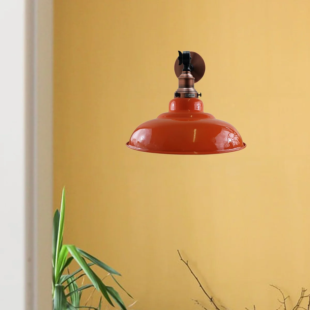 Orange wall light featuring a curvy adjustable swing arm and metal shade, installed on a wall in a living room setting