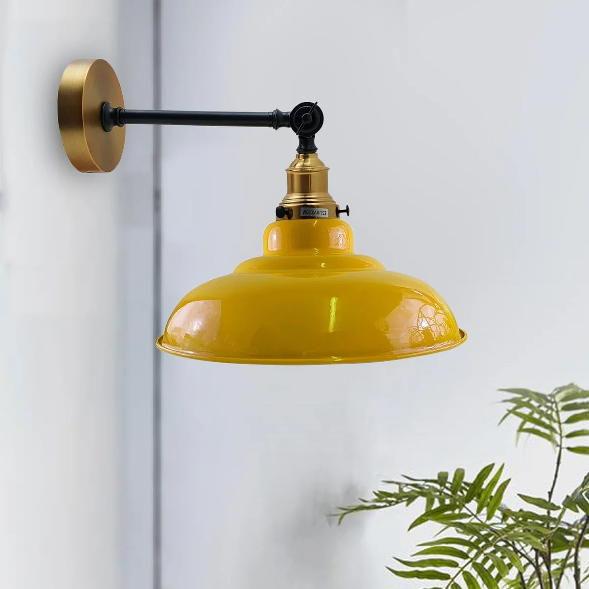Yellow adjustable wall lamp with curved metal shade and sophisticated swing arm.