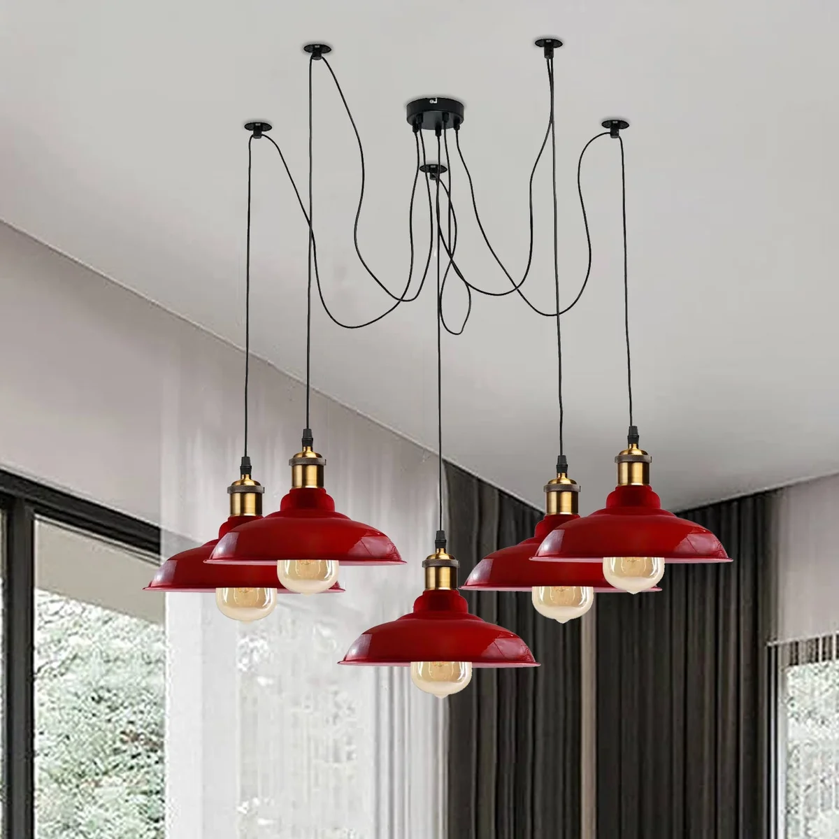 Five‑armed industrial pendant light with glossy metal shades and adjustable cables in black, hanging over a dining table