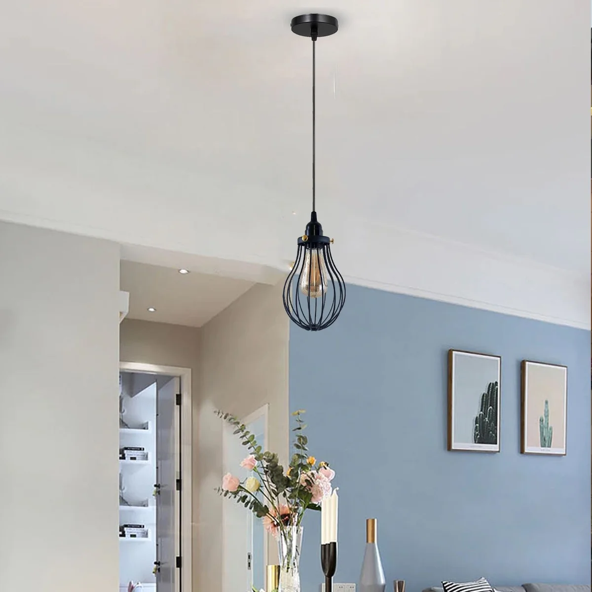 Black cage pendant light with three metal lamps hanging from adjustable 95cm cable, styled for contemporary industrial decor.
