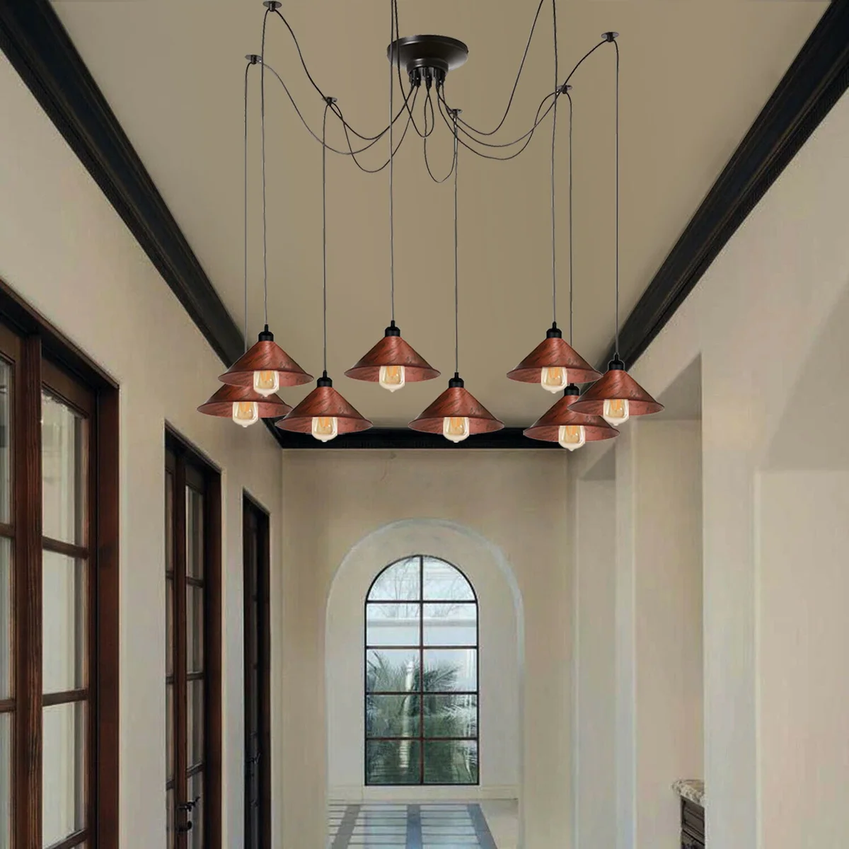 Industrial pulley chandelier with 8 arms, each holding an E27 filament bulb, in rustic red finish, mounted on a ceiling rose.