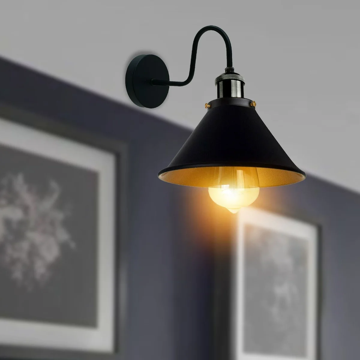 Metal wall lights with cone-shaped shade, brushed brass finish.