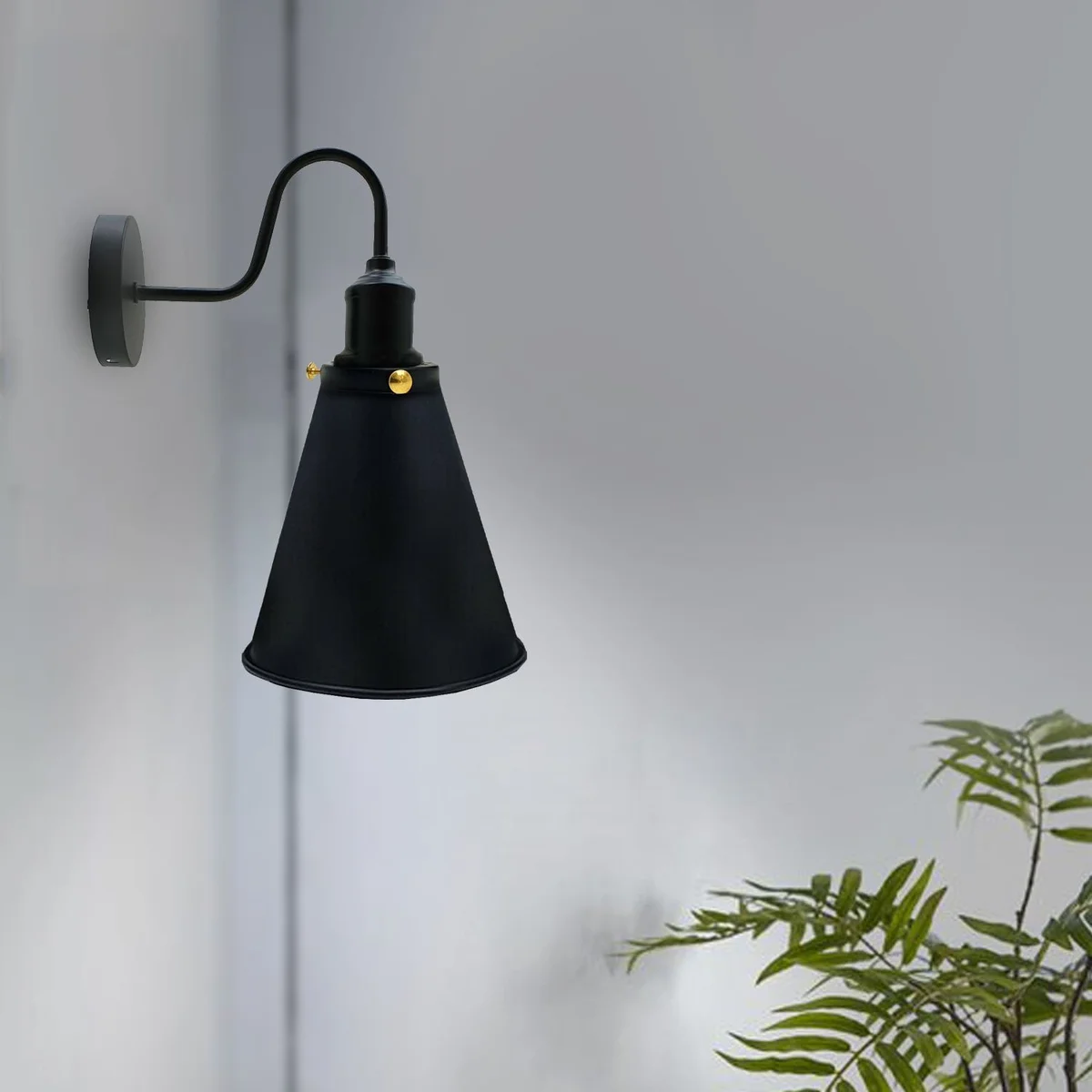 Black metal cone-shaped vintage industrial wall light with metal arm, hanging from ceiling, suitable for modern indoor use