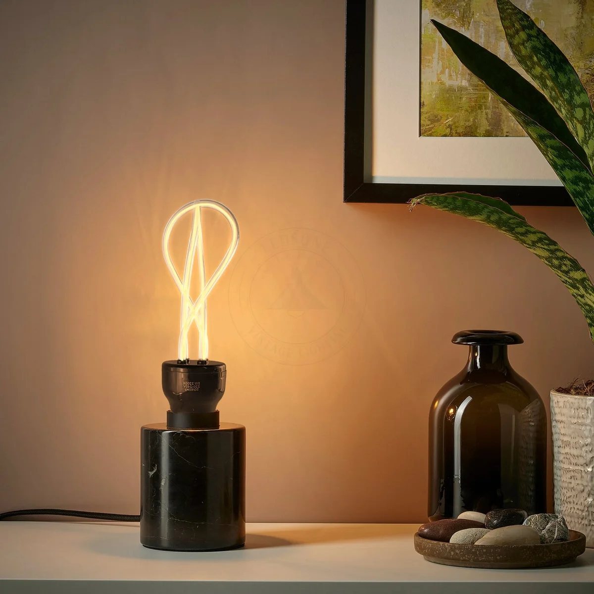 Three amber‑tinted E27 LED bulbs with soft neon filament in sleek industrial sockets