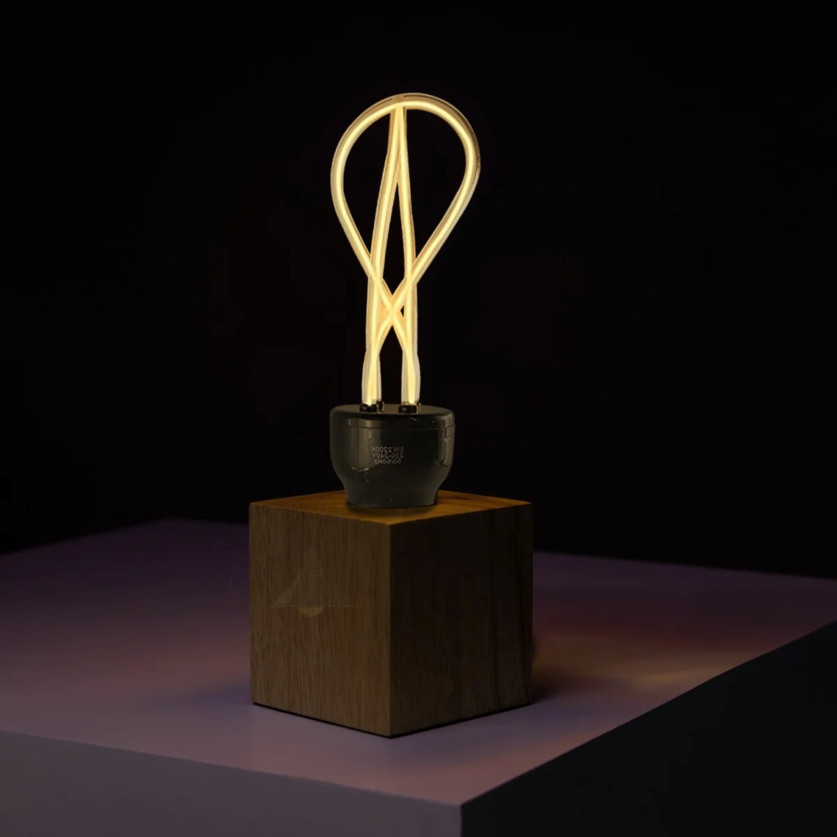 Bulb with soft neon filament, amber tinted glass for industrial style lighting.