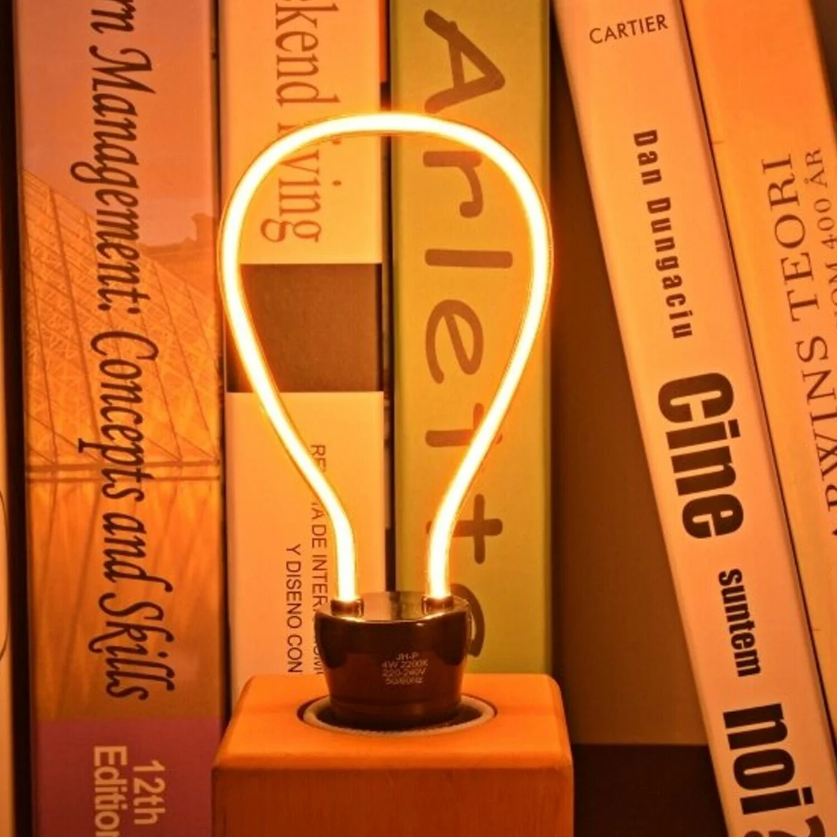 Three 4W LED filament bulbs with warm yellow glow, glass housing and curling filament, fitted on E27 base