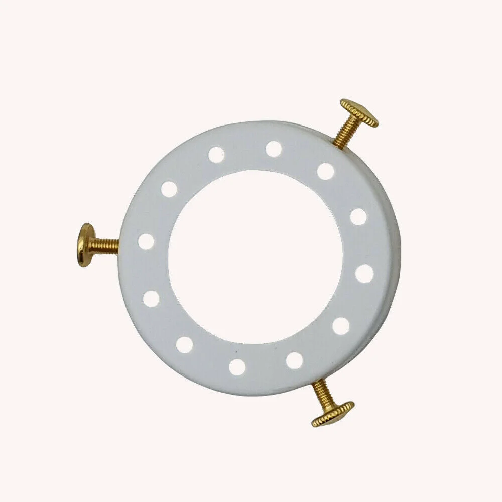 White metal lamp shade cap (7 cm diameter, 1.5 cm height) covering an E27 socket, fitted to pendant light.