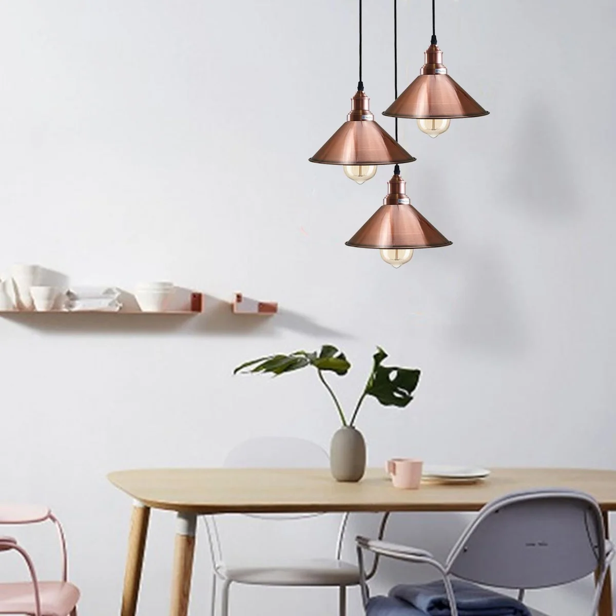A sleek 3 way pendant light in steampunk style with rose gold, copper and silver metal clusters hanging from a 95 cm PVC cable