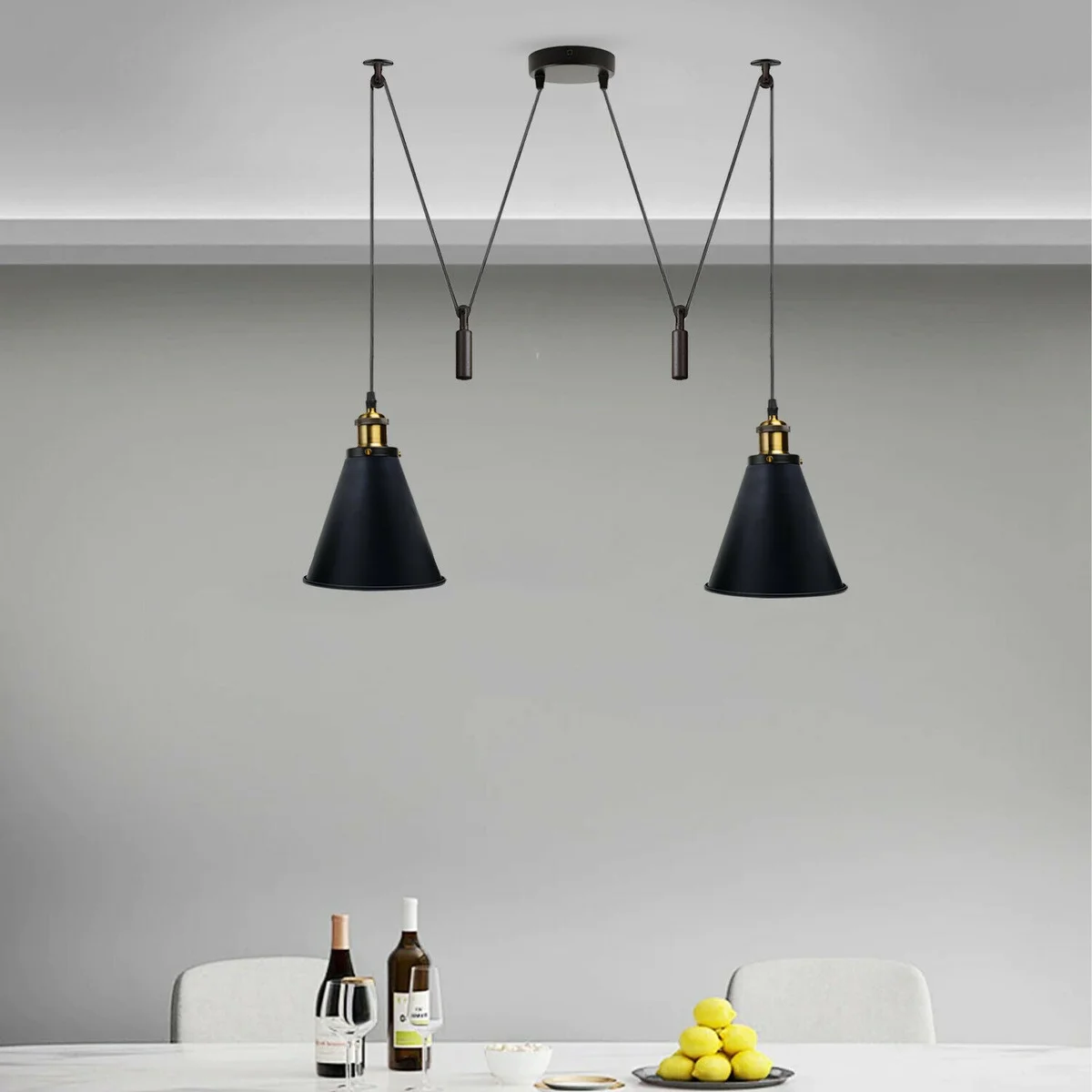 Dual head ceiling light with black metal pulleys and long adjustable cables.