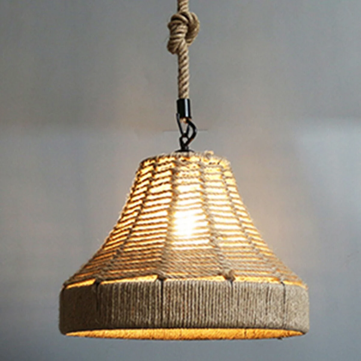 Industrial hemp rope pendant light in a woven rope cage, hanging from metal hook.