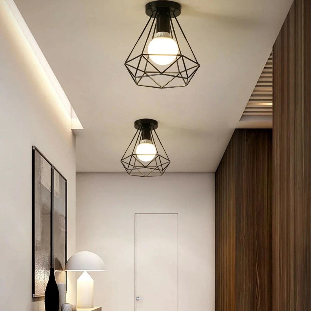 Black and rose gold cage ceiling light with metal shade, showing an E27 socket and 10.8cm base set against a wall.