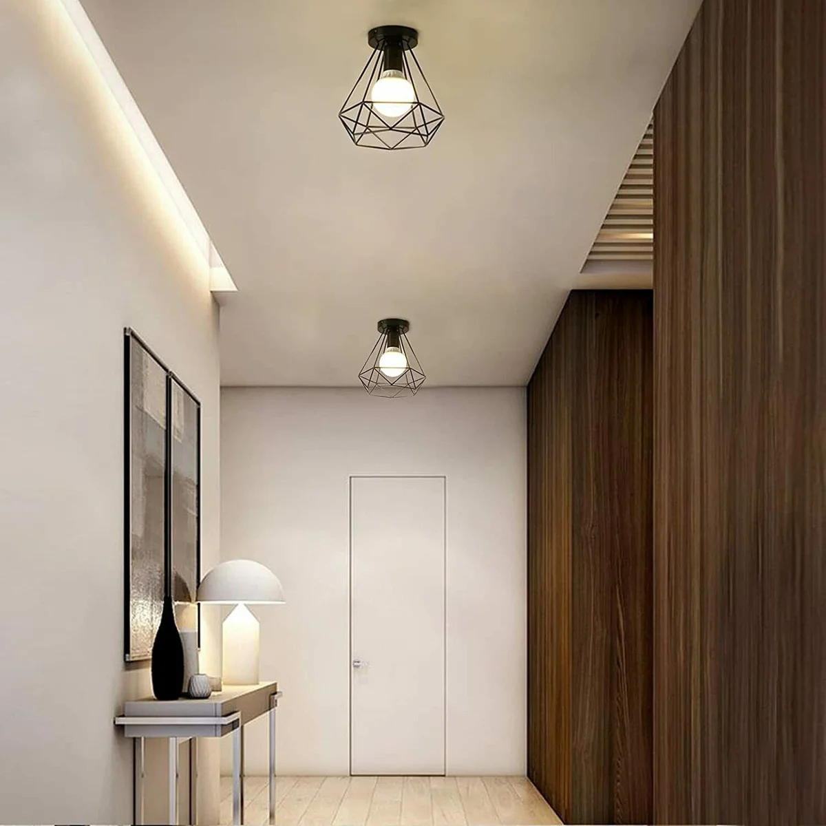 Black and rose gold metal cage light shade mounted on a ceiling, showing a sleek black frame with subtle rose gold accents.