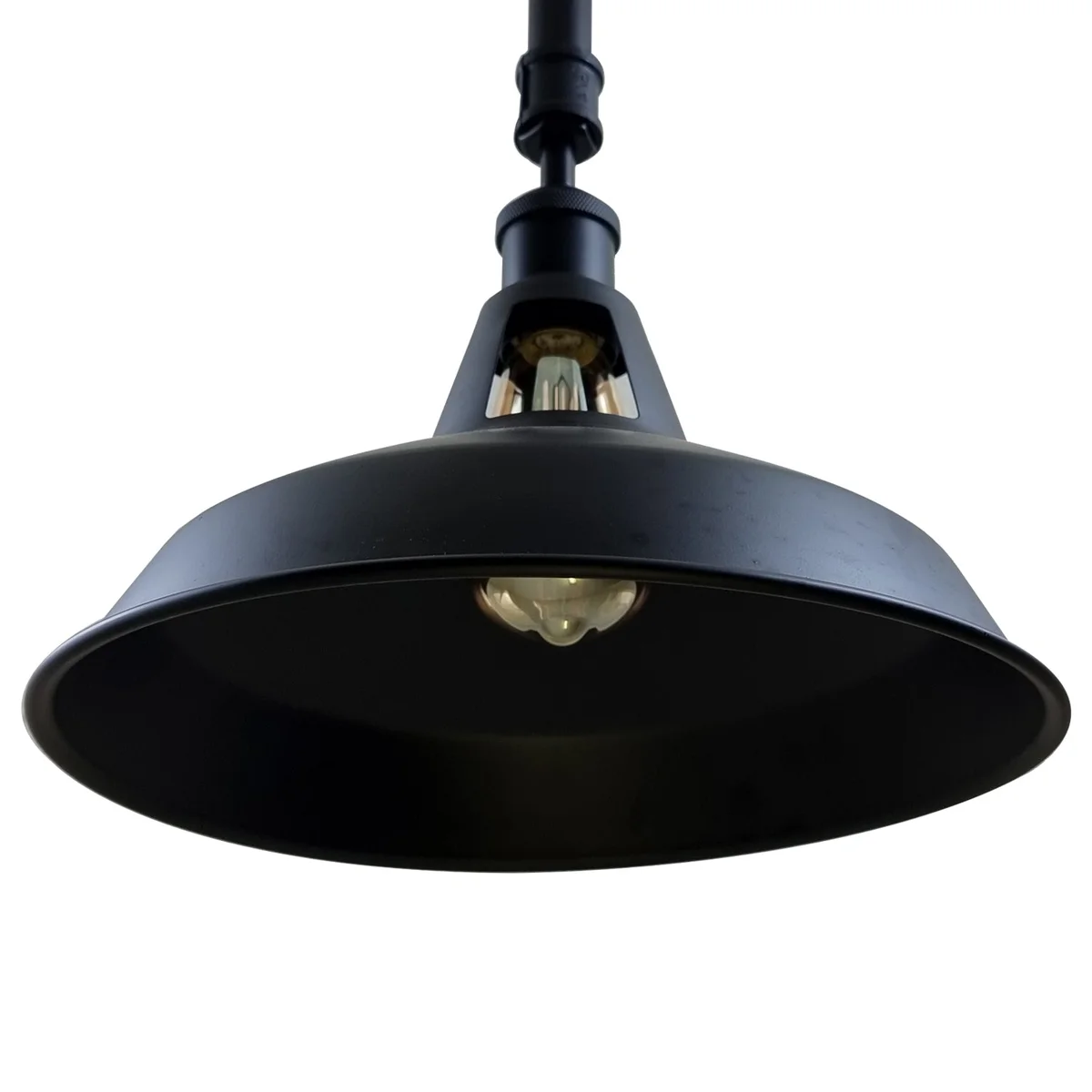 Black metal ceiling light on ceiling, iron industrial design with round matte surface, E27 bulb socket, vintage rusted style.