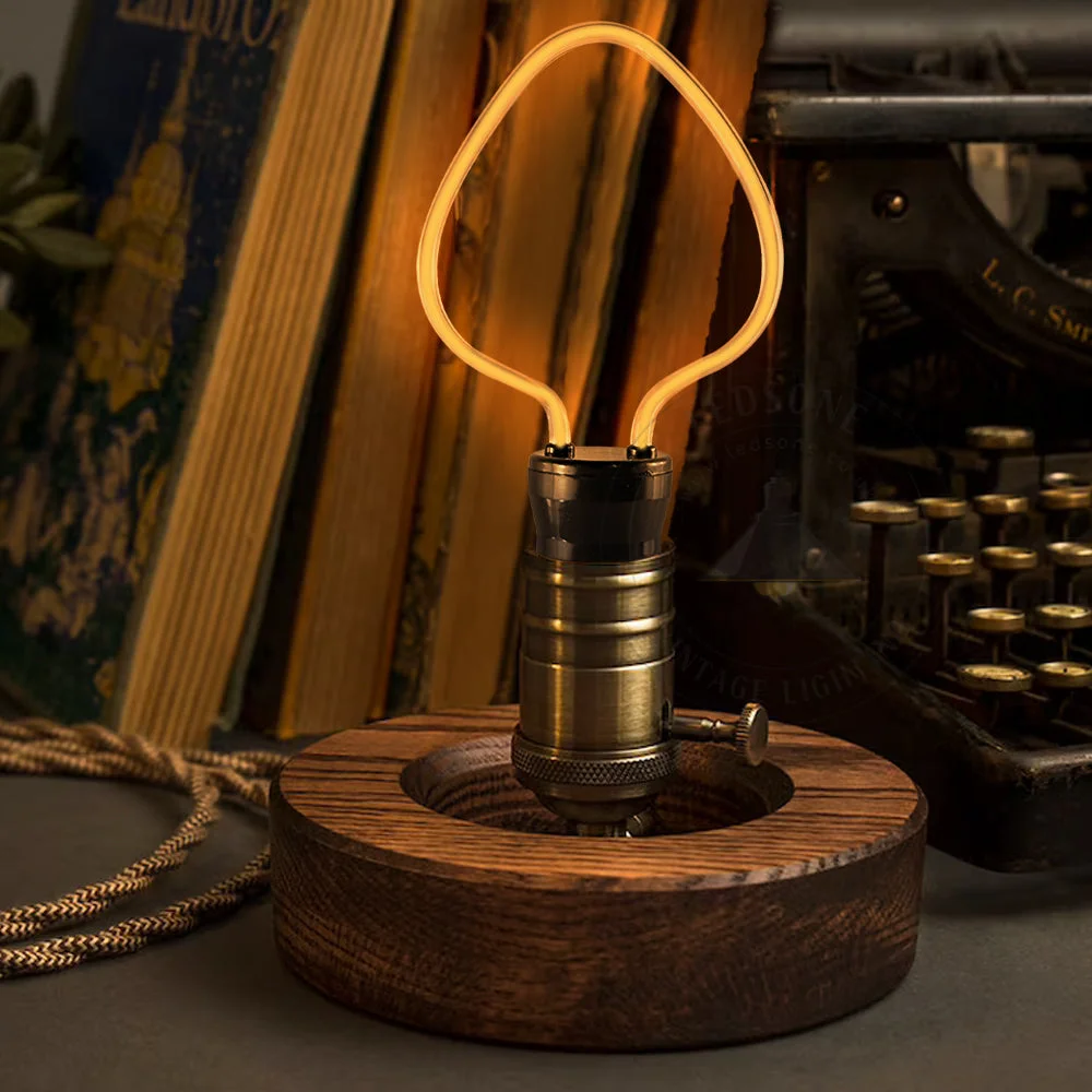 Designer 4W LED bulb with curvy filament, warm yellow glow, glass body, copper base, Edison screw fitting, vintage look