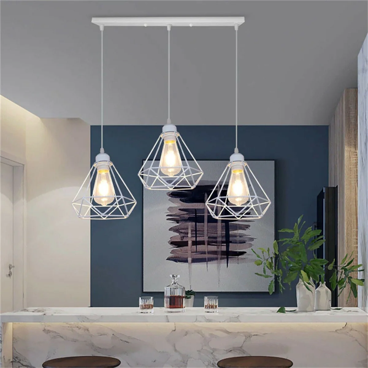 Vintage cage pendant light with white diamond-shaped metal cage hanging from ceiling, offering geometric industrial style.